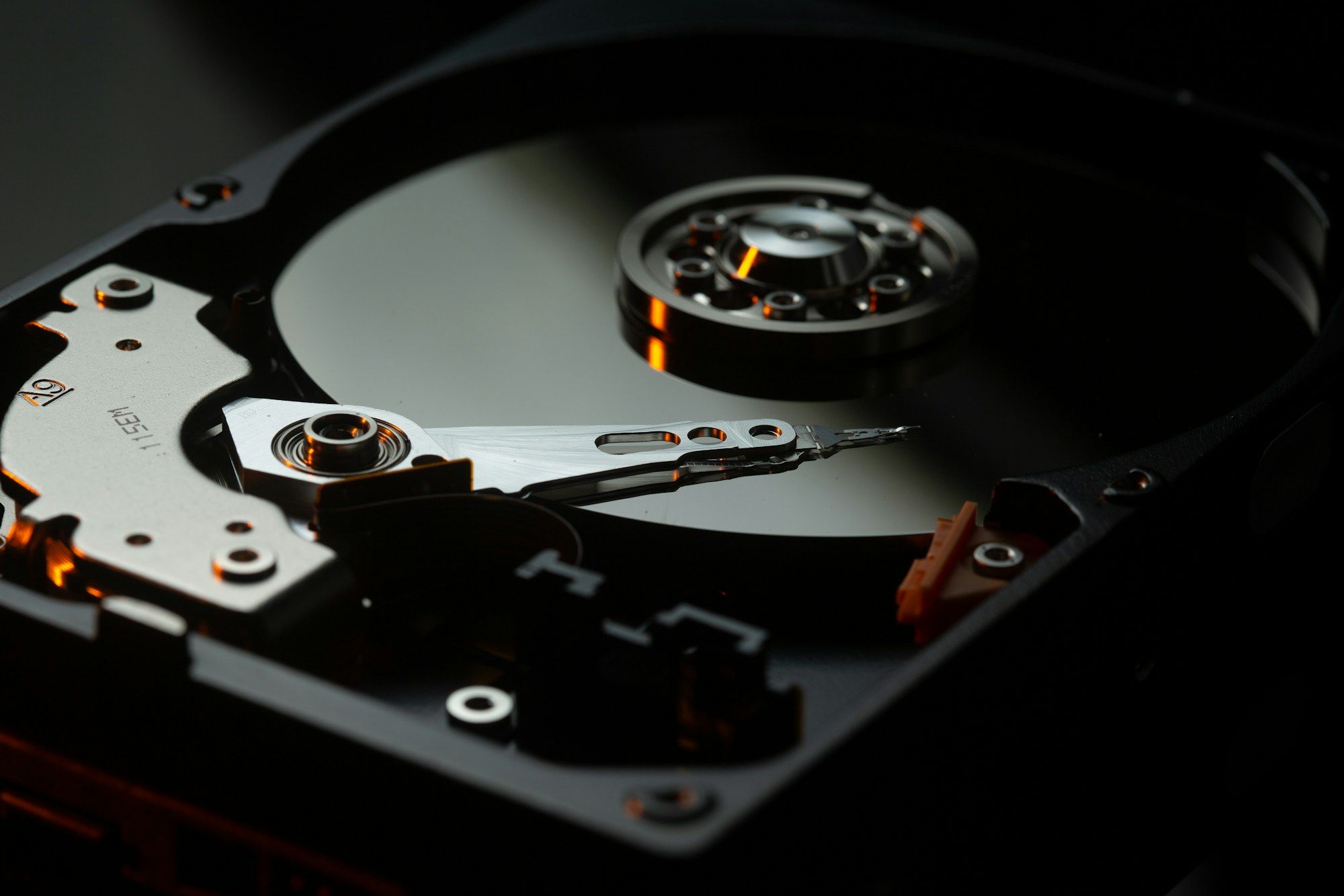 Open hard drive showing platter and read head
